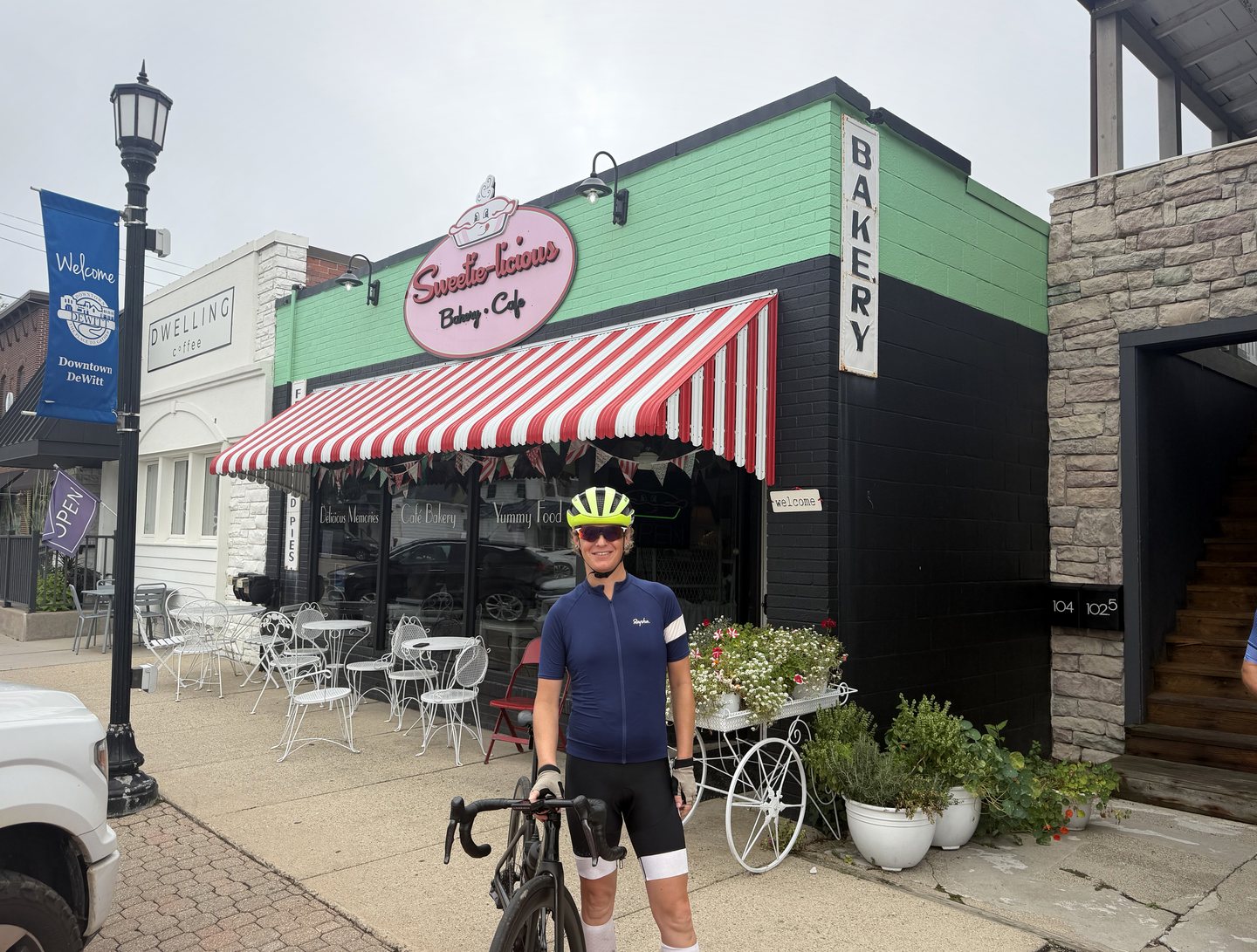 A cyclist standing with a bicycle outside a bakery in Westphalia.