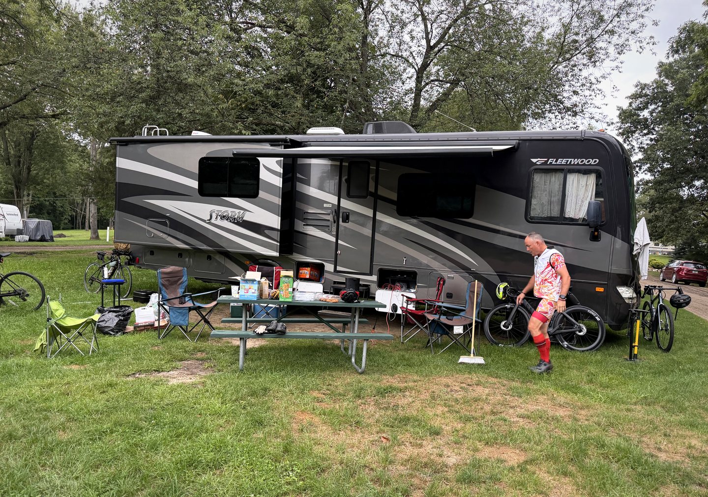 The team packing bicycles and supplies beside the RV at the final campsite.